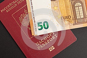 Russian foreign international passport and euro on a black background