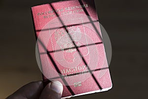 Russian foreign passport in the hands of a man. Prohibition of Schengen visas for Russian tourists to travel to the