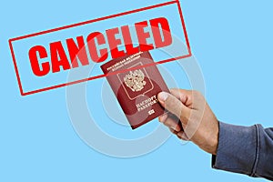 Russian foreign passport in the hands of a man. Prohibition of Schengen visas for Russian tourists to travel to the