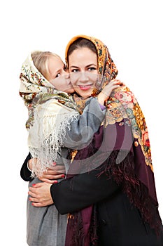 A russian girl in a headscarf is kissing mother