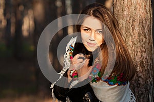 Russian girl in headscarves near the tree in the forest