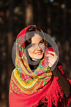 Russian girl in national headscarves with apple