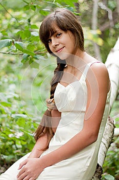 Russian girl in white dress in a birch forest