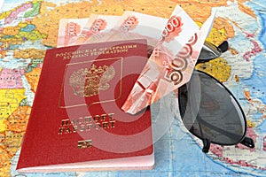 Russian international passport, money, sunglasses and origami pl