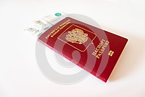 Russian international passport and paper money, rubles on white table