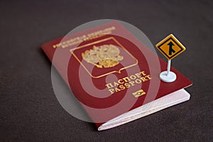 Russian international passport with a yellow arrow road sign - migration concept
