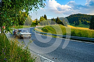 Russian Lada VAZ - 2160 against the backdrop of a beautiful landscape with green meadows