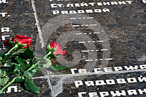 Russian language phrase `sergeant,major, colonel,lieutenant, ranker` - army ranks, flowers on the memorial to fallen soldiers, r