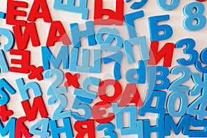 Russian letters and numbers. Red vowels and blue consonants on a white background.