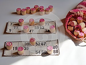 Russian lotto, bingo board game, barrels and cards on a white background. Quarantine Games Concept. Board game lotto with wooden