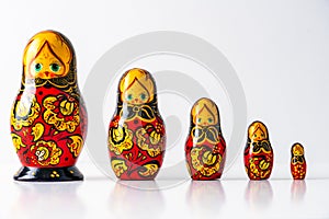 Russian matryoshka dolls on a row on white isolated studio background. With copy space fot text