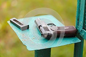 Russian 9mm handgun PM Makarov on the table with holster, belt and empty pistol holder