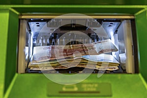 Russian money in the ATM cash acceptor. Close-up photo
