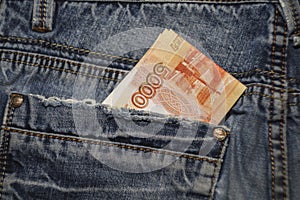 Russian money in the back pocket of blue jeans