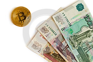 Russian money and bitcoin on white background