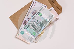 Russian money is on the envelope. Paper bills of five hundred and one thousand rubles.