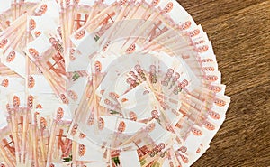 Russian money with a face value of five thousand rubles is lying on the table, close-up. The concept of Finance. Background and