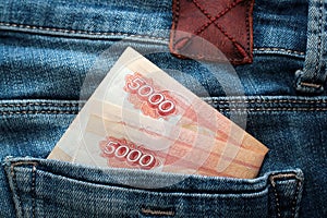 Russian money roubles in blue jeans pocket as a top view image