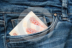 Russian money roubles in blue jeans pocket as a top view image