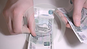 Russian money rubbles over white table Hands count money slow motion hd footage