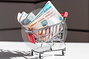 Russian money in Shopping Cart. Banknotes of Russian rubles. Cash, currrency, banknotes bank Russia. Wealth financial