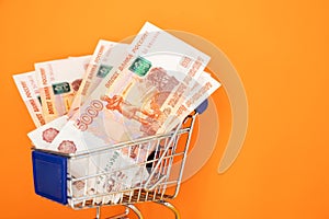 Russian money in Shopping Cart. Banknotes of Russian rubles. Cash, currrency, banknotes bank Russia. Wealth financial