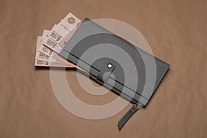 Women`s wallet with Russian rubles. Russian money bills in a gray wallet