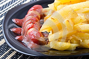 Russian national dish - fried sausage and potatoes