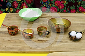 Russian national wooden utensils. Products for making dumplings, pies. Eggs, flour for dough