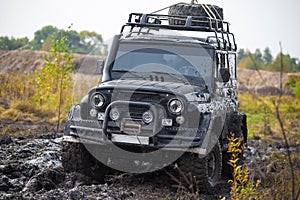 Russian off road car UAZ in mud