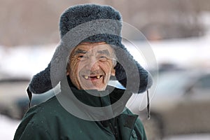 Russian old man in winter hat smiles