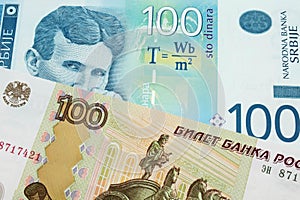 A Russian one hundred ruble note paired with a blue and white one hundred Serbian dinar note.