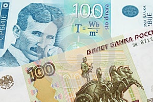 A Russian one hundred ruble note paired with a bue and white one hundred Serbian dinar note.