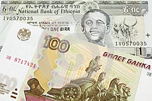 A Russian one hundred ruble note paired with a grey Ethiopian one birr bill.