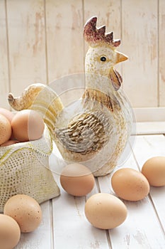 Russian organic food, Easter decor card with eggs and decorative ceramic cock, vertical image
