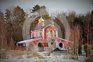 Russian Orthodox church with golden dome on the background of the autumn forest