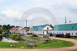 Russian outback landscape with old houses and abandoned trucks