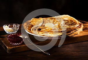 Russian pancakes crepes with butter and raspberry jam