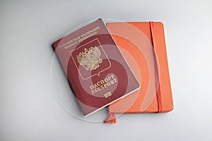Russian pasport and red note book on grey background photo