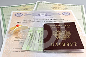 Russian passport with baby dummy and maternal, birth and pension