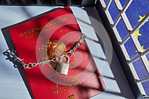 Russian passport chained in a chain with a padlock is located. Prohibition of Schengen visas for Russian tourists.