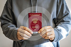 Russian passport in the hands of a man. Prohibition of Schengen visas for Russian tourists to travel to the European