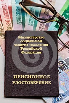 Russian pension certificate, glasses and russian rubles banknotes