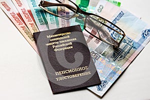 Russian pension certificate, glasses and russian rubles banknotes