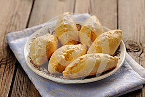 Russian pirogi, small pies on blue linen