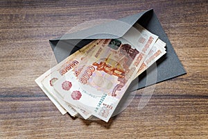 Russian rouble banknotes and envelope on table