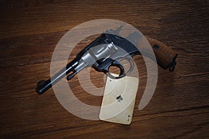 Russian roulette - Ace of Spades plaing card and revolver with one cartridge in drum