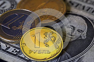 Russian Ruble Euro and US Dollar Coins on Dollar Banknote. Ukraine war sanctions exchange rate concept. Macro