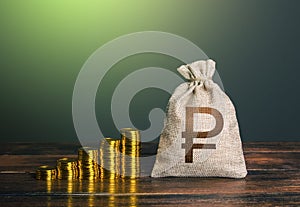 Russian ruble money bag and increasing stacks of coins. Rise in profits, budget fees. Investments. Raise incomes, increase