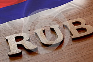 Russian ruble word concept made of wooden letters rub on wooden background with Russian flag